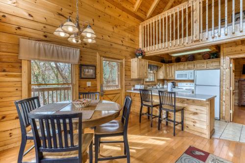 a dining room and kitchen with a table and chairs at Affair of the Heart in Pigeon Forge