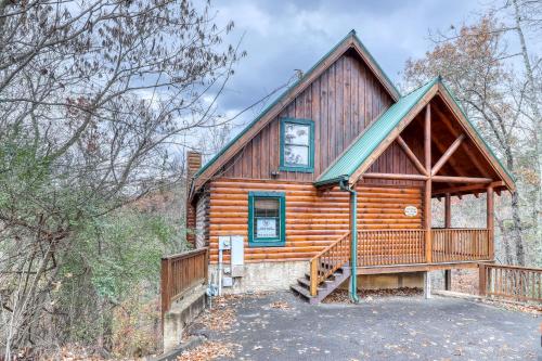 a cabin in the woods with a large deck at Affair of the Heart in Pigeon Forge
