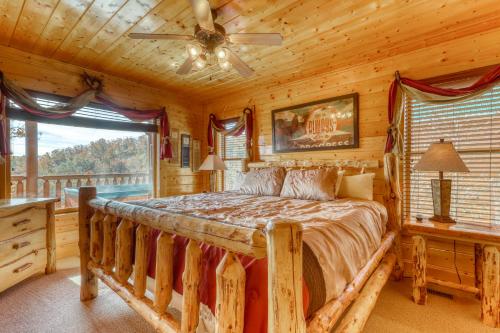 a bedroom with a large bed in a log cabin at Hillbilly Highrise in Pigeon Forge