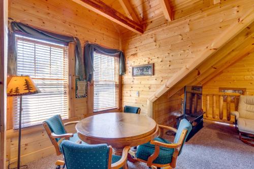 a dining room with a wooden table and chairs at Tennessee Treasure in Pigeon Forge
