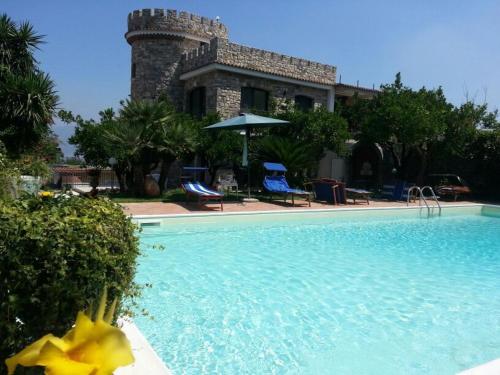 a swimming pool in front of a house at Villa Le Favole in Sant'Egidio del Monte Albino