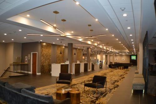 a lobby with couches and chairs in a building at Wyndham Lancaster Resort and Convention Center in Lancaster