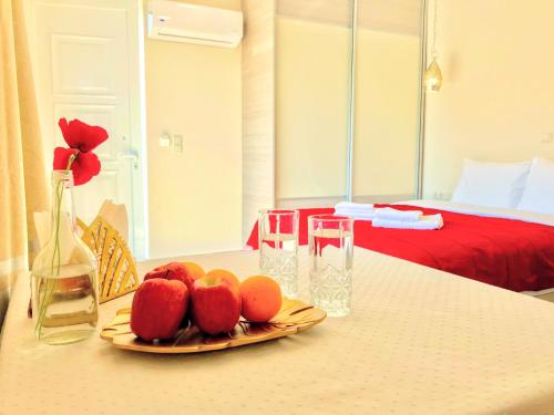 a plate of fruit on a table in a bedroom at SEMIRAMIS SUITES with pool in Kalamata
