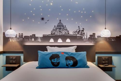 a bedroom with a bed with two people painted on it at Hôtel Lucien & Marinette in Paris