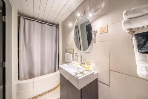 a bathroom with a sink and a mirror at Hotel Rapids in Grand Rapids