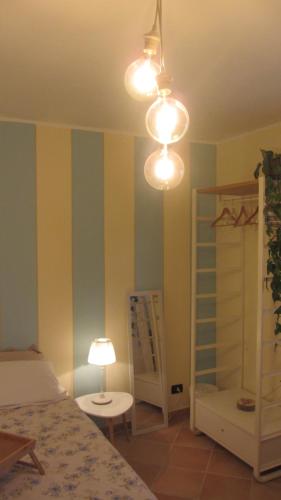 a bedroom with a bed and a table and a lamp at Cascina Bellezza in Poirino