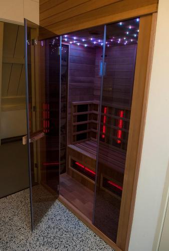 a glass shower with red lights in a room at BB88 in Leeuwarden