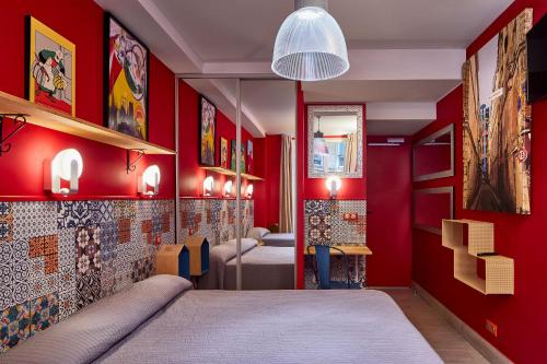 a bedroom with red walls and a bed in a room at Hôtel de Roubaix in Paris