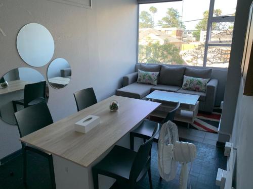 a living room with a table and a couch at JFT self catering units in East London
