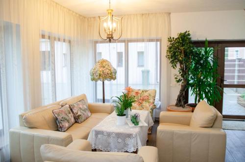 a living room with two couches and a table at Park Apartments in Valmiera
