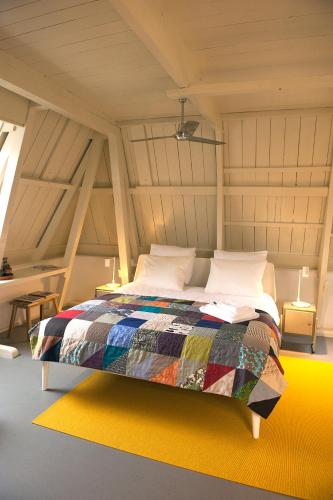 a bed with a colorful quilt in a room at BB88 in Leeuwarden