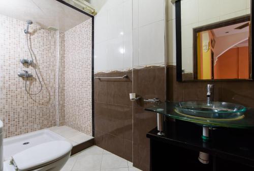 a bathroom with a sink and a toilet and a shower at rico,s house in Agadir