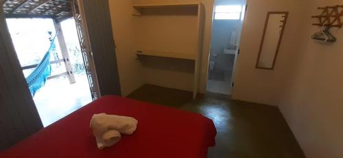 a room with a red table with a white object on it at Stay Cool Pipa in Pipa