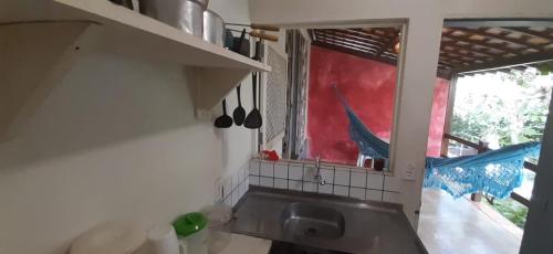 a kitchen with a kitchen sink and a window at Stay Cool Pipa in Pipa
