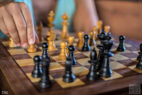 a person is playing chess on a chessboard at Ajo Aloha Hostel in Cabo Polonio