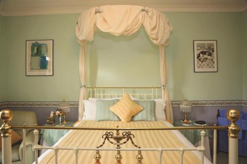 a bedroom with a bed with a canopy at Forgandenny House B&B in Mudgee