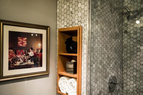 a bathroom with a shower with a picture and a shower at The Hollywood Roosevelt in Los Angeles