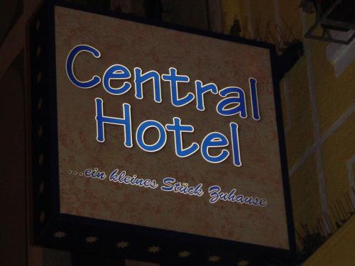 a sign for a central hotel on a wall at Central Hotel in Worms
