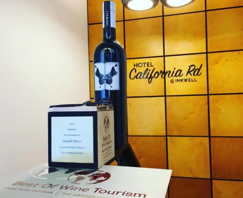 a bottle of wine and a box on a table at Hotel California Road at Inkwell Wines in McLaren Vale