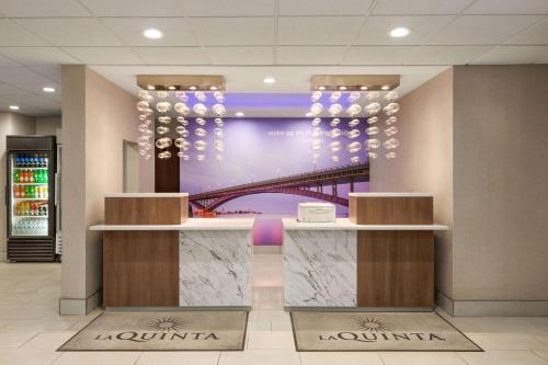 a lobby of a building with a picture of a bridge at La Quinta by Wyndham Lackawanna in Lackawanna