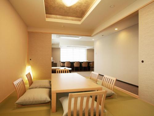 a dining room with a table and chairs at Auberge de South Terrace in Shirahama