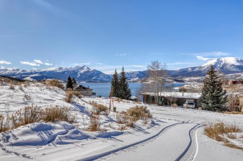 a road covered in snow with mountains in the background at 615 Oro Grande in Dillon