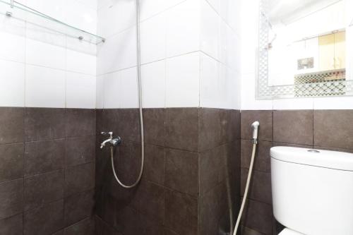 a bathroom with a shower with a toilet at Green Pramuka City by SR Property in Jakarta