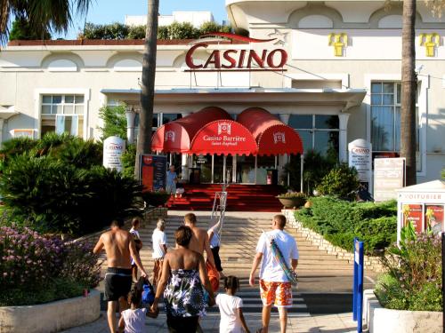 a group of people walking in front of a casino at Nouvel Hotel in Saint-Raphaël