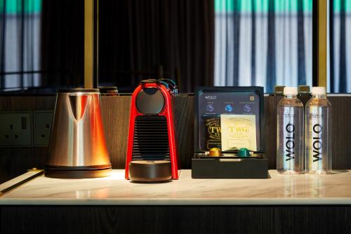 a table with a blender and other items on it at WOLO Kuala Lumpur in Kuala Lumpur