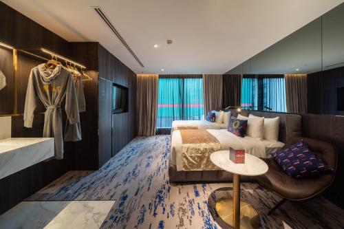 a hotel room with a bed and a couch at WOLO Kuala Lumpur in Kuala Lumpur