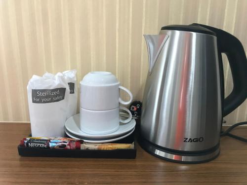 a coffee maker sitting on a table next to a coffeemaker at TTT Hotel in Hat Yai