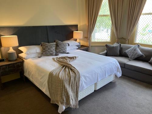 a bedroom with a large bed and a couch at St. Elizabeth's Home in Melbourne