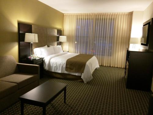 a hotel room with a bed and a couch at Holiday Inn Mexico Santa Fe by IHG in Mexico City