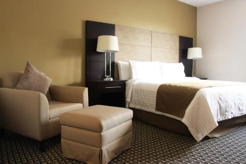 a hotel room with a bed and a chair at Holiday Inn Mexico Santa Fe by IHG in Mexico City