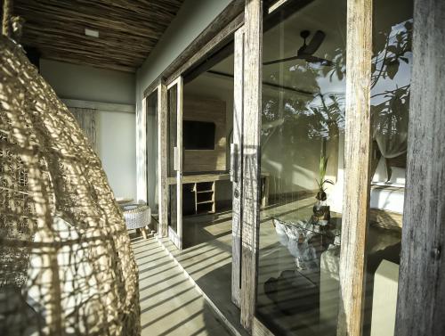 a glass door of a house with a patio at Angsoka Bungalow in Ubud