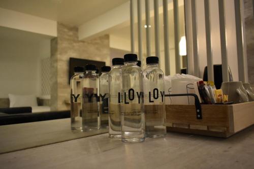 a group of glass bottles sitting on top of a table at Loyy Hotel in Chiang Mai