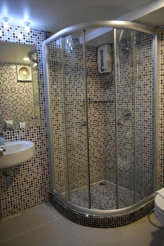 a bathroom with a shower and a sink at Loyy Hotel in Chiang Mai
