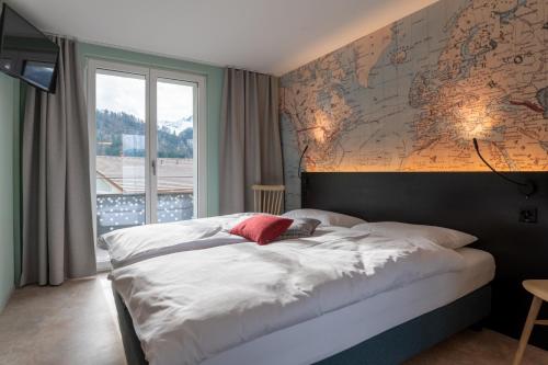 a bedroom with a large map on the wall at Emma's B&B - Self Check-in Hotel in Lungern