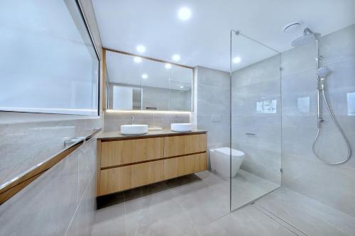 a bathroom with two sinks and a shower at Pacific Regis Beachfront Holiday Apartments in Gold Coast