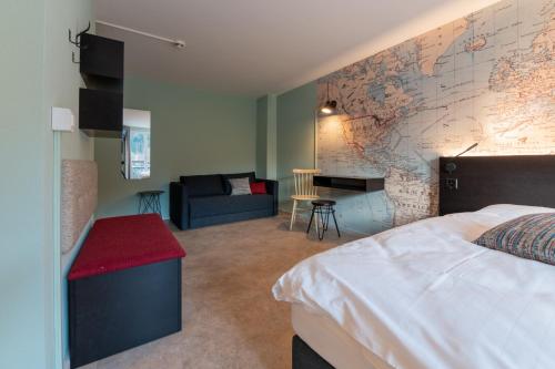 a bedroom with a bed and a map wall at Emma's B&B - Self Check-in Hotel in Lungern