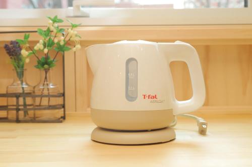 a tea kettle sitting on top of a table at JR Mobile Inn Sapporo kotoni in Sapporo