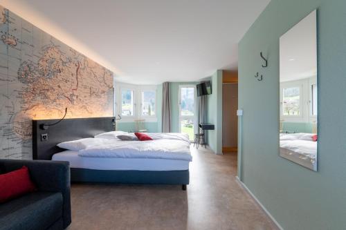 a bedroom with a bed and a large mirror at Emma's B&B - Self Check-in Hotel in Lungern