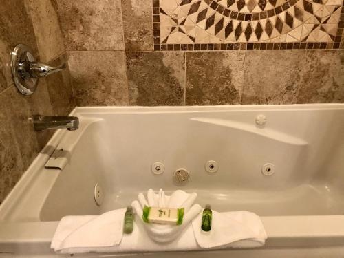 a white bath tub with towels in a bathroom at Inn at the Prom Oceanfront in Seaside