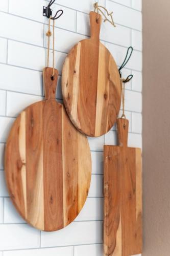 two wooden cutting boards hanging on a wall at Emma's B&B - Self Check-in Hotel in Lungern