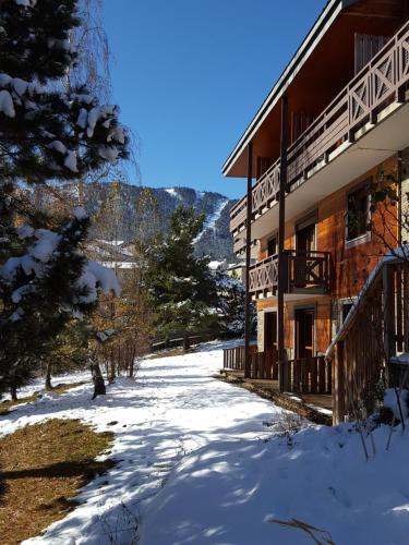 un chemin enneigé devant un bâtiment dans l'établissement VVF Résidence Les Angles Pyrénées, aux Angles