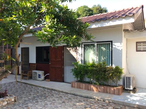 a small house with a door and some plants at Pimpa House พิมพาเฮาส์ in Ban Hua Nam Mae Sakut