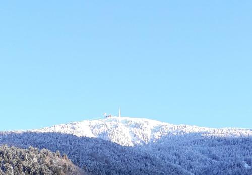 a snow covered mountain with a cross on top of it at Landhaus Zangerl - Kobelerhof in Landeck
