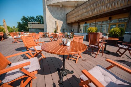 a wooden table and chairs on a patio at Kazakhstan Express in Almaty