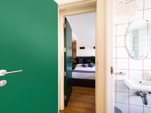 a bathroom with a sink and a bed in a room at Hostal Athenas in Sant Adria de Besos