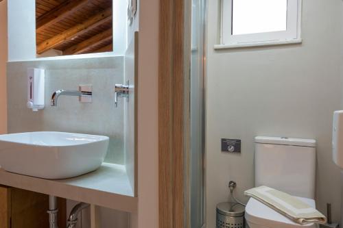 a bathroom with a sink and a toilet at Pantanassa Villas in Agia Marina Nea Kydonias